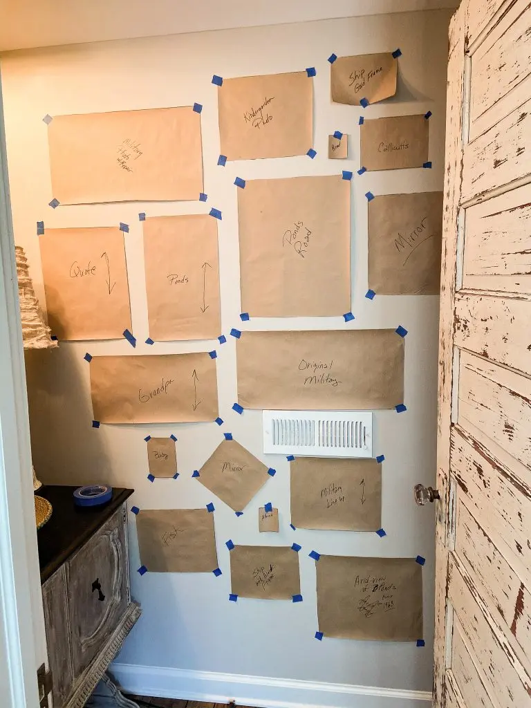 Use your paper templates and painters tape to arrange your wall.  This will allow you to see a the wall before placing any nails.  This will assure no mistakes when hanging a gallery wall.