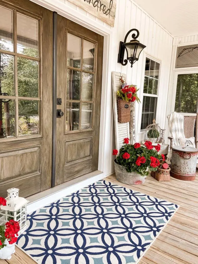 Adding a new rug and fresh flowers updates a front porch.  Keep you porch looking Summertime Fresh all season long.  