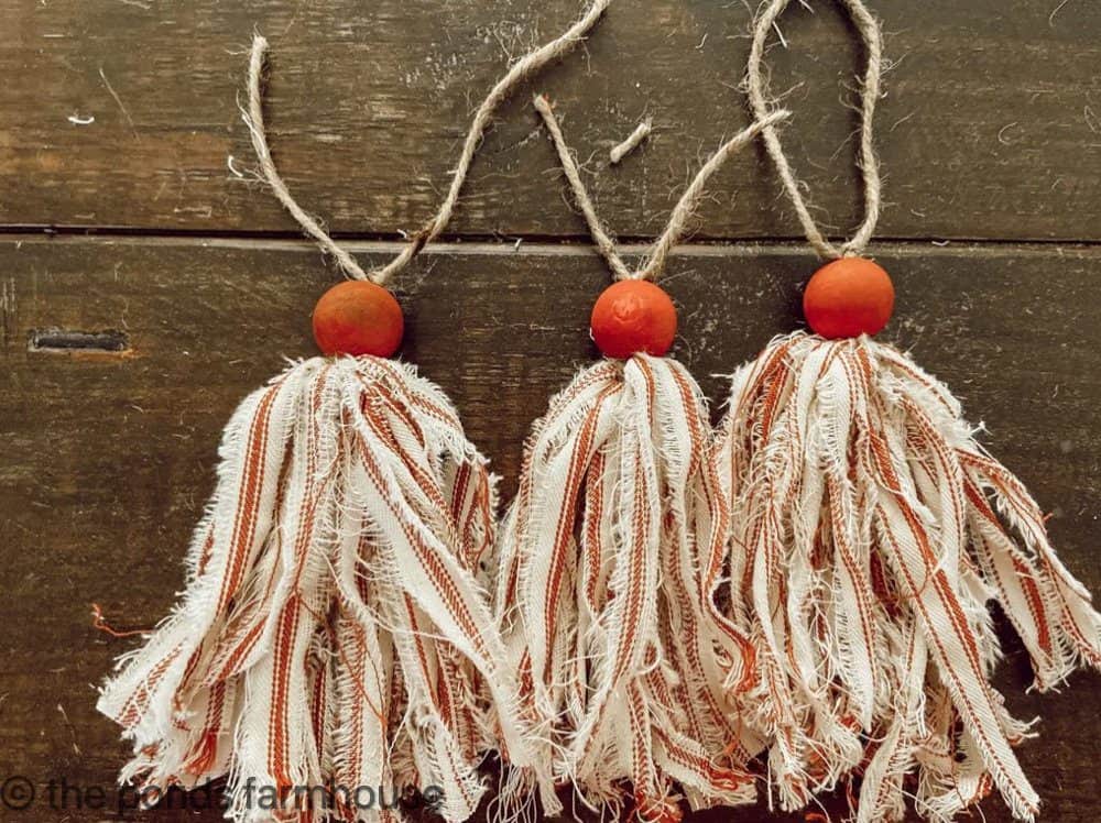 Red and White Ticking Fabric for DIY Christmas Tassels with wooden balls for creative tassel decoration ideas. 