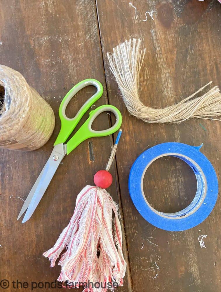 Supplies for making DIY Christmas Tassels - Jute twine, scissors, painters tape 