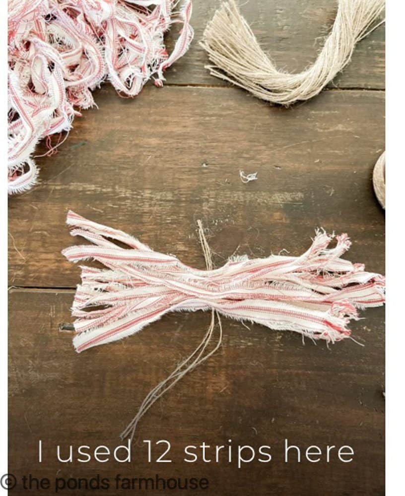 tie red and white ticking fabric together to make DIY tassels for Farmhouse Christmas Decorating