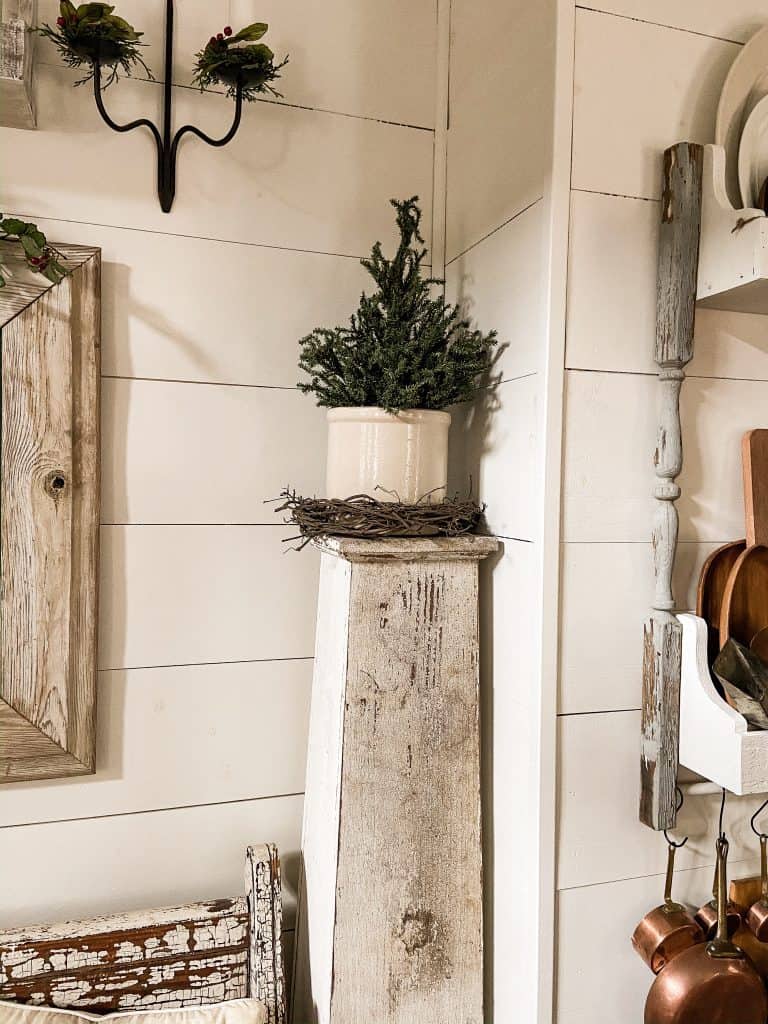 Thrifted Christmas Tree in vintage crock on architectural salvage porch column.  Chippy White Paint 