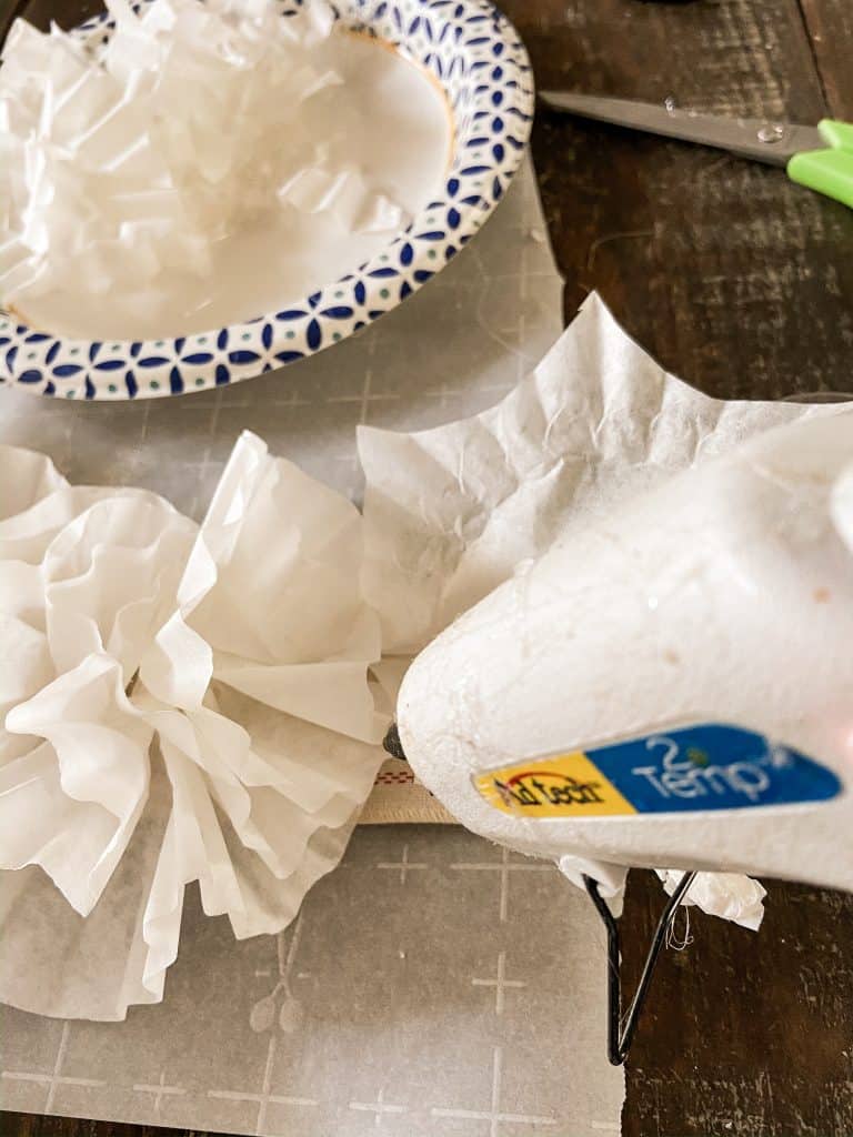 use hot glue to attach coffee filter crafts to runner.  