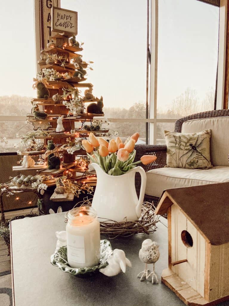 Easter shiplap tree with Easter decorations, slate coffee table with pitcher and birdhouse.