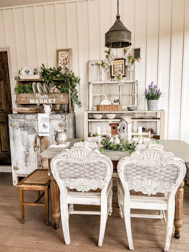 Easter themed tablescape, vintage icebox, background vintage windows, vintage chairs. Screened in porch Easter theme.