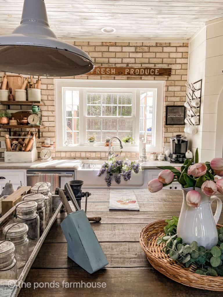 Brick wall and shiplap for added texture in farmhouse kitchen design ideas.  
