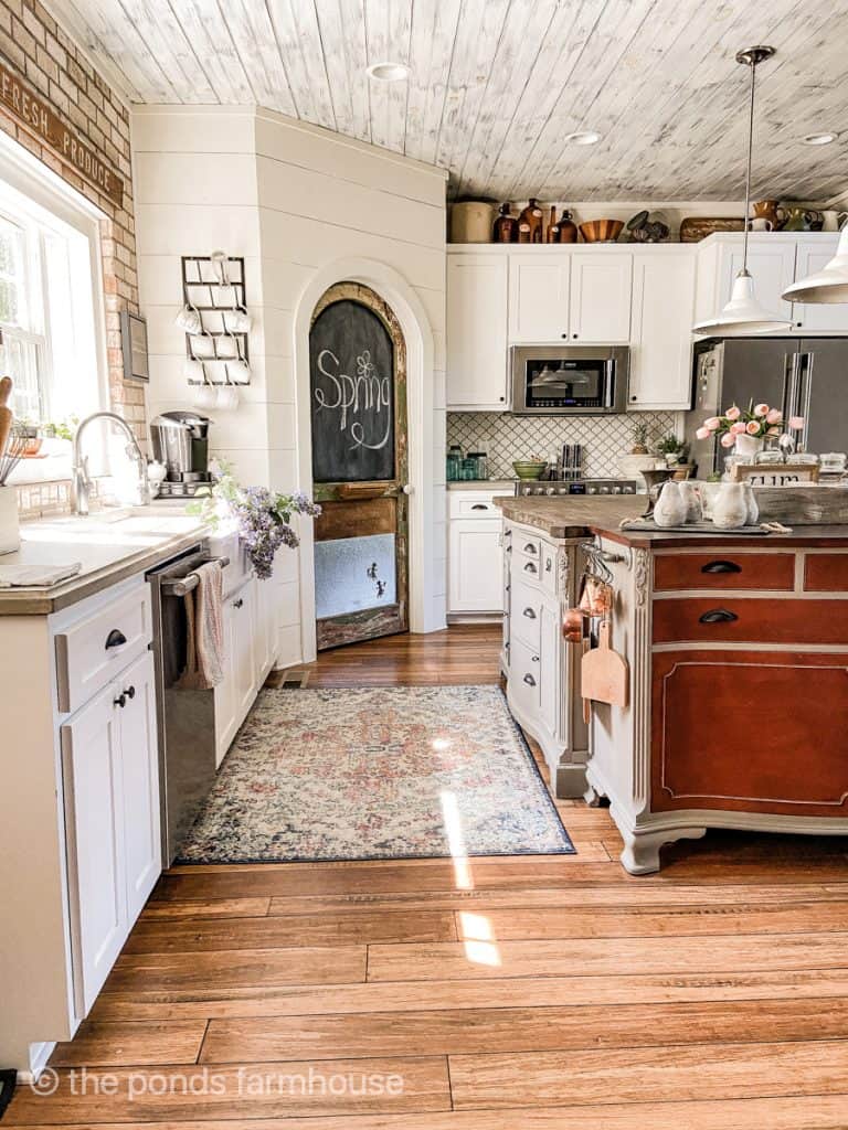 Farmhouse Style Kitchen with DIY Island, Pantry Door, shaker cabinets in white and shiplap wall.