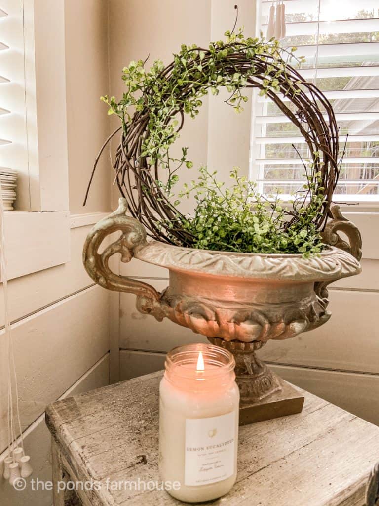 DIY Topiary in concrete urn with handles in bathroom  with candle
