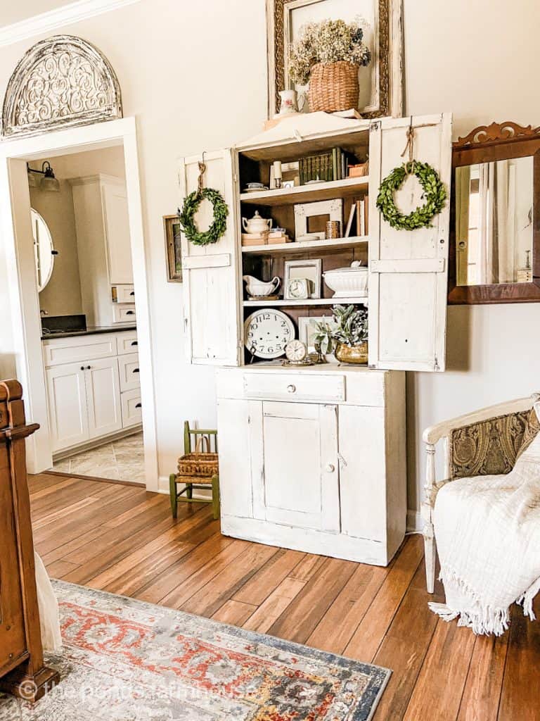 Step back hutch holds vintage treasures to decorate the bedroom..