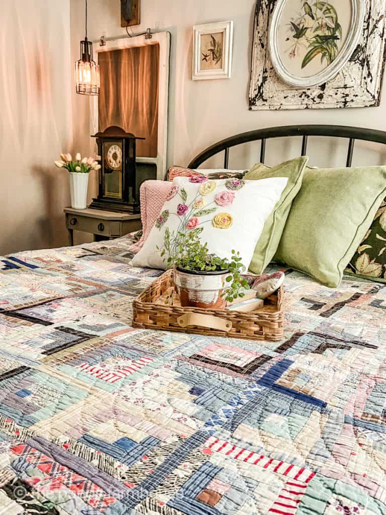 Vintage & Antique bedroom decor create a unique look.  Vintage quilt and DIY Flower Pillow Cover.