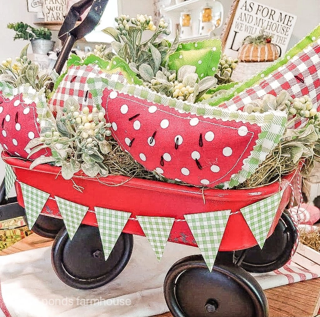 Red wagon with DIY watermelons for a fun festive summer centerpiece.