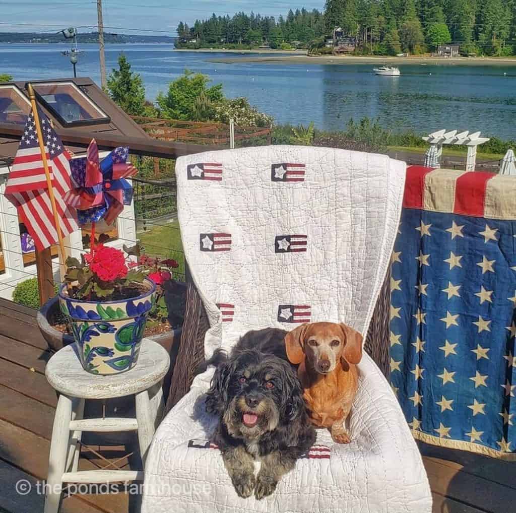 Vintage quilts for patriotic decorating on a deck overlooking the water.