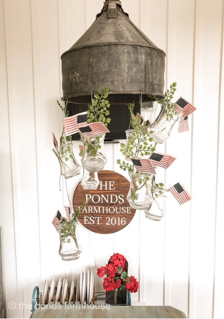 DIY mini flags in vases hanging from DIY funnel light fixture for memorial day and 4th of July
