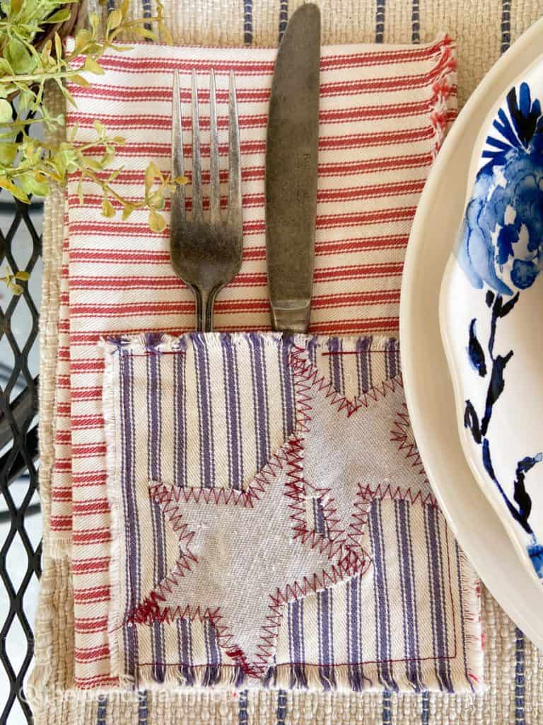 Patriotic DIY Napkins with cutlery pockets with antique pewter silverware next to blue & white plate