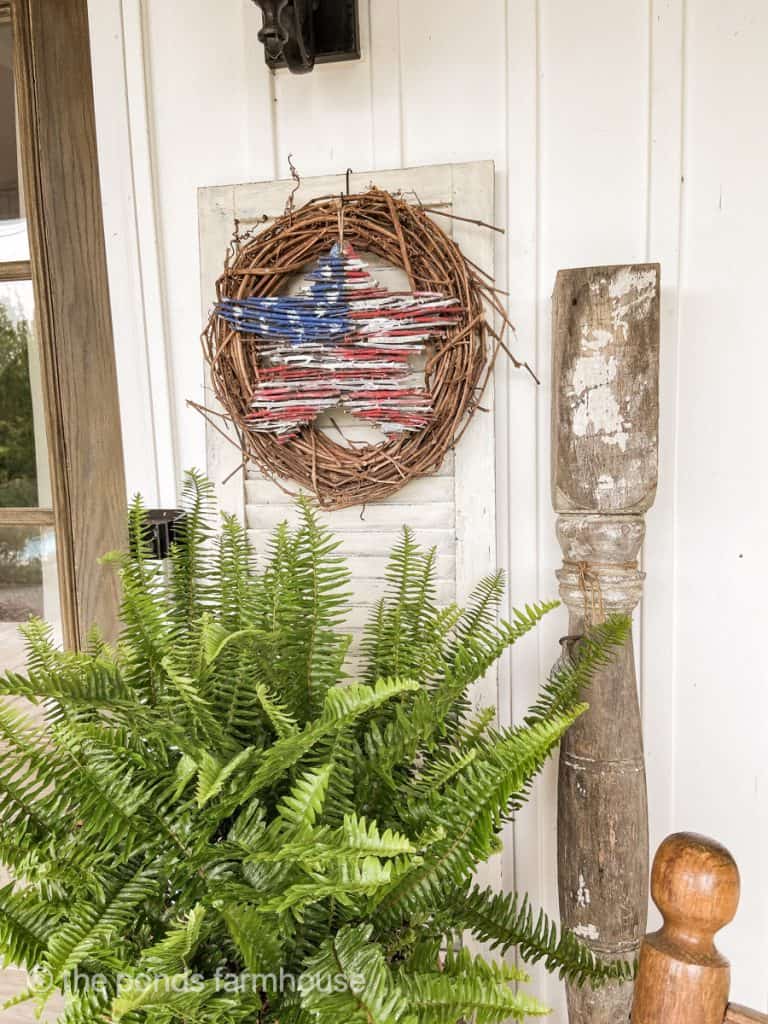 Wooden patriotic star wreath attached to shutter. DIY Craft Project from foraged materials.