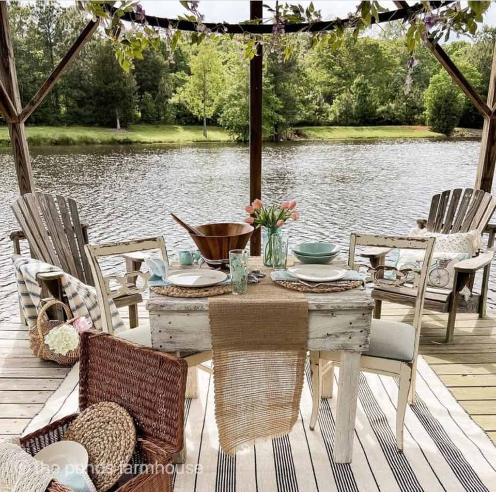 Outdoor Rug on Pier with dining table and Adirondack chair, picnic basket. The Ultimate Guide To Choosing Best Outdoor Rug For Your Space