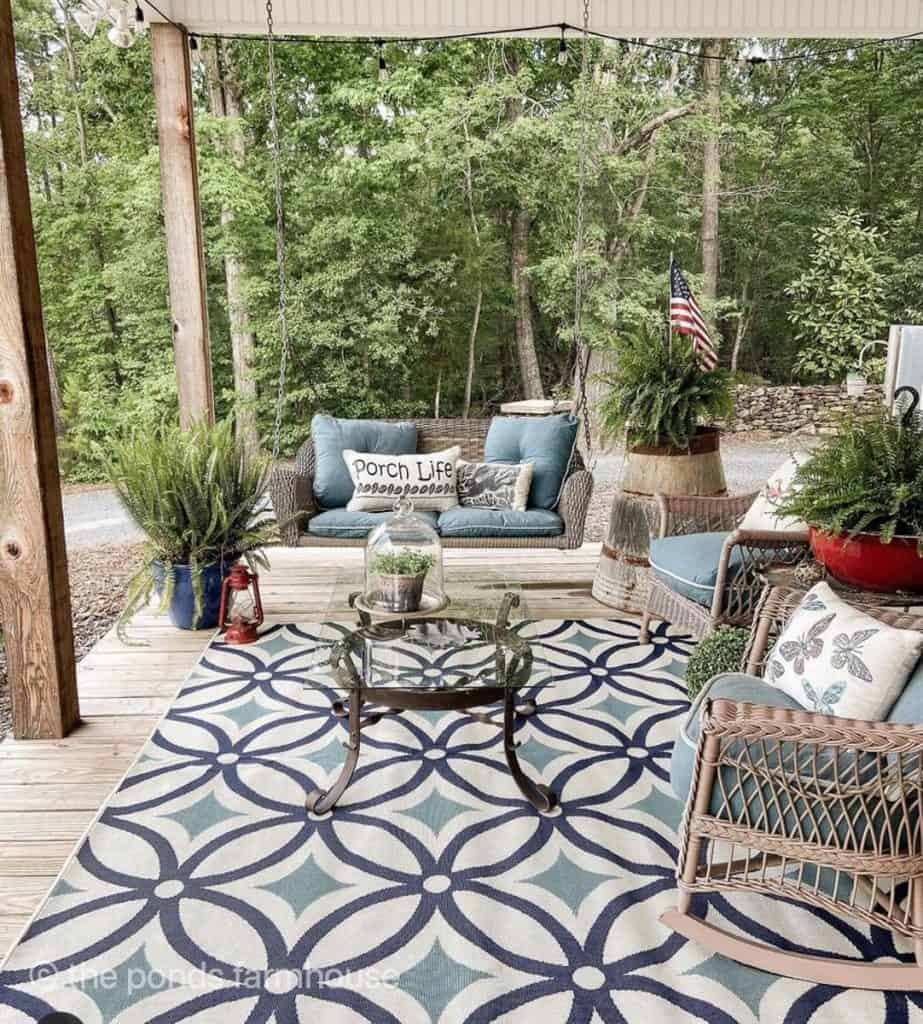 Porch outdoor rug ideas with blues and whites for front porch seating area.  Porch swing.
