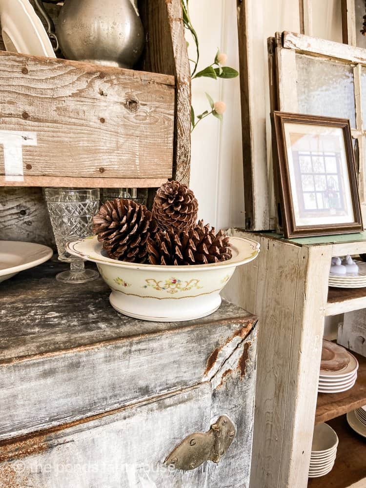 Damaged thrift Store Finds used for holding pinecones for budget-friendly cheap home decor.