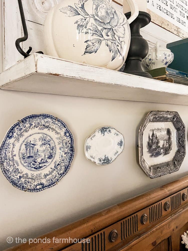 Vintage dinner plates hang on the wall as one thrift store shopping tip.