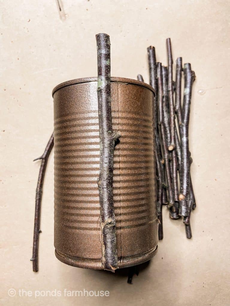 Show how to add twigs to a tin can using hot glue.  Easy tutorial