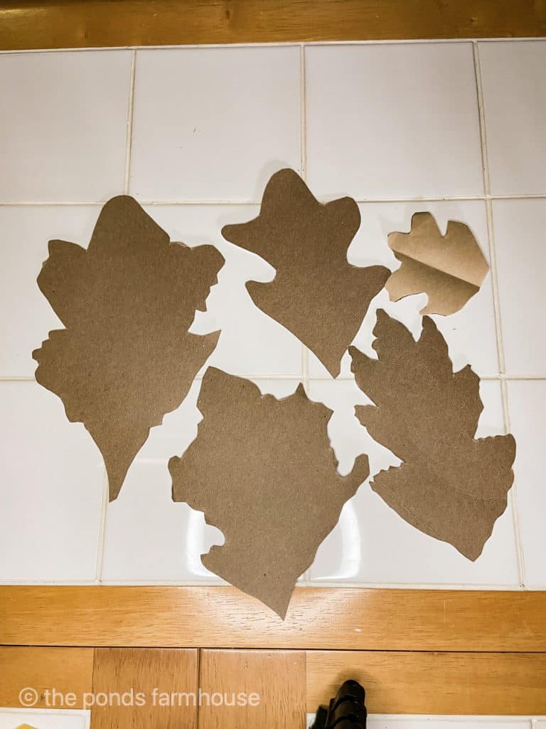 Cut leaves from kraft paper for fall craft ideas.