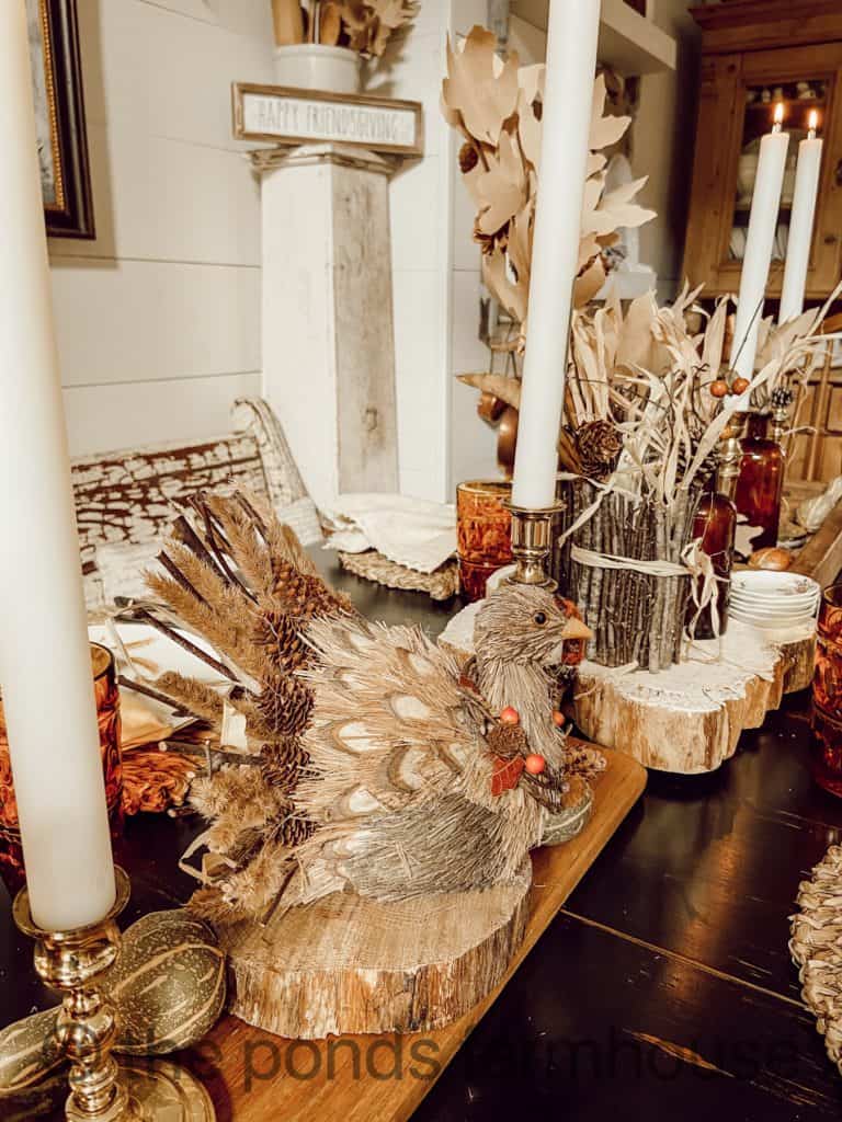 Thanksgiving Table Decor Ideas include everlasting candles and rustic turkey.