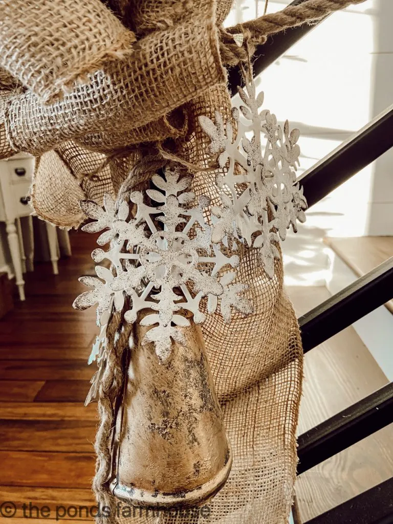 Close up view of burlap bow at the end of the banister Christmas Garland