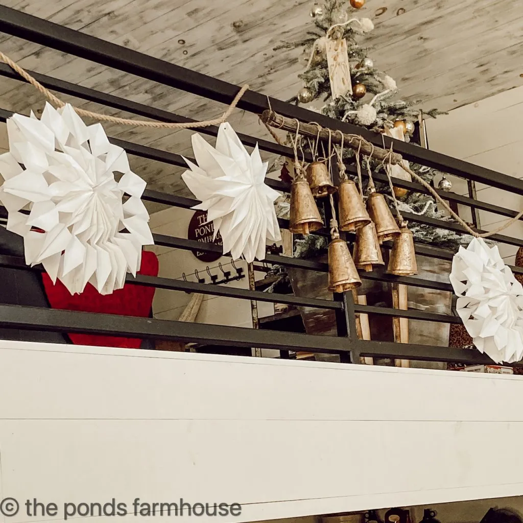 Brass Bell Art in centerpiece of the Christmas Garland on loft banister for Industrial farmhouse Style Christmas