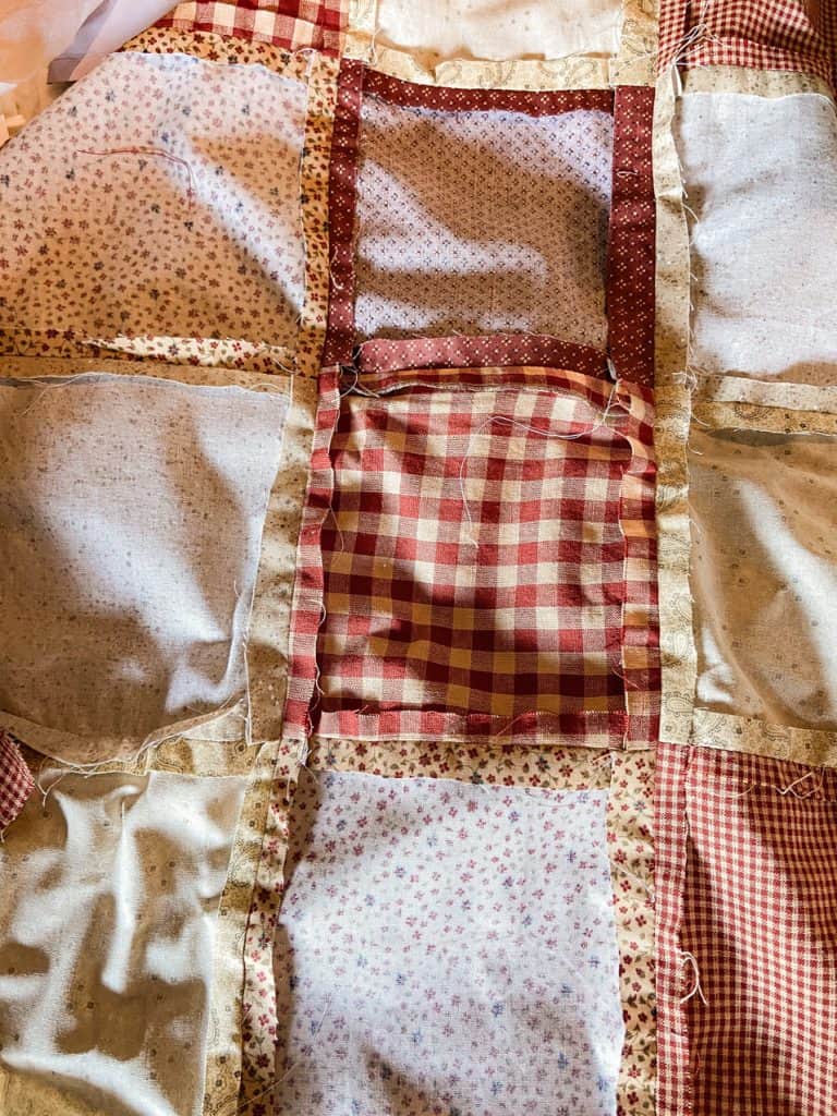 See Christmas tablecloth from backside with seams pressed open.