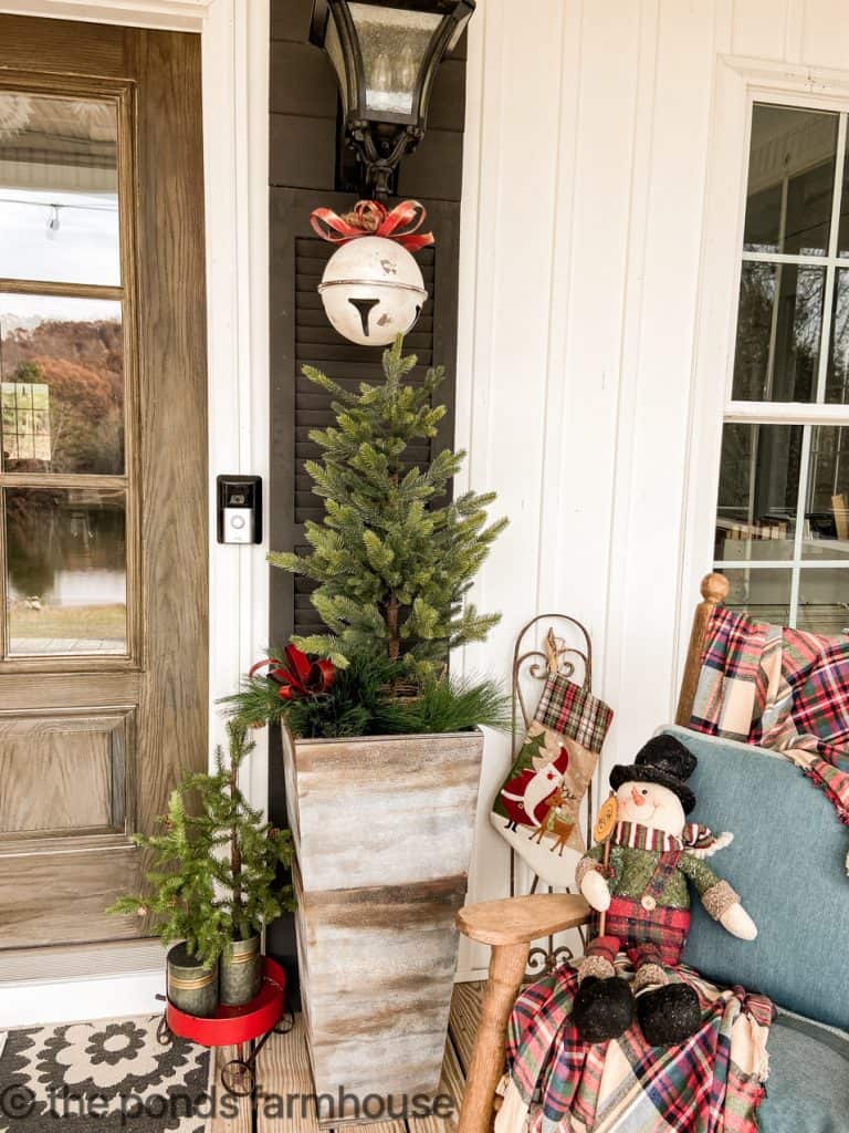 Farmhouse Outdoor and Front Porch Christmas Decorations.  Include white bells and bare Christmas trees.  