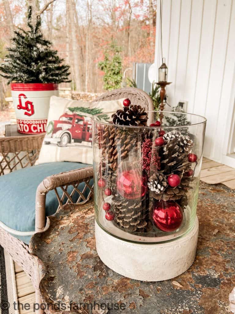 Close up of pinecones, berries & red ornaments.