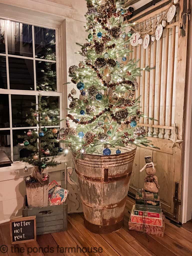 Night time view of Rustic Farmhouse Style Christmas Tree in Vintage European Olive Hod. Budget Friendly Christmas decorating.