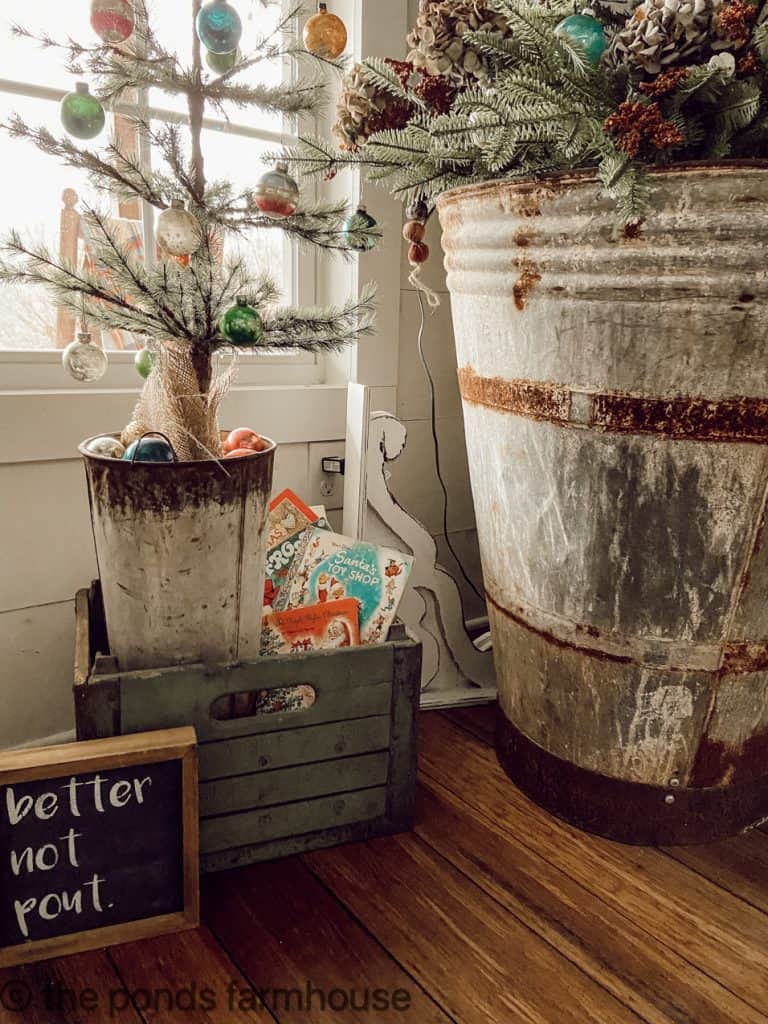 Both Christmas trees are in a vintage zinc container with a rusty crusty finish for a rustic farmhouse feel. 