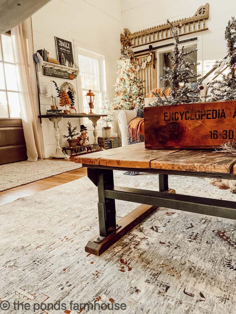 Vintage Wood Box filled with flocked Christmas Trees on Repurposed Industrial Coffee Table.