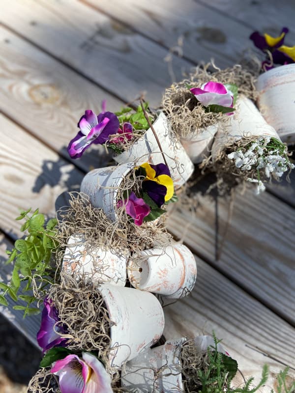 fill pots with pansies and moss from Dollar Tree to make a DIY Spring Wreath