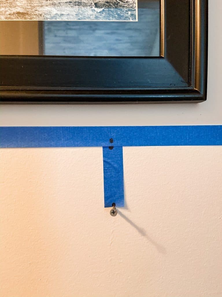 Use tape for correct nail placement for How To Hang A Picture Frame.