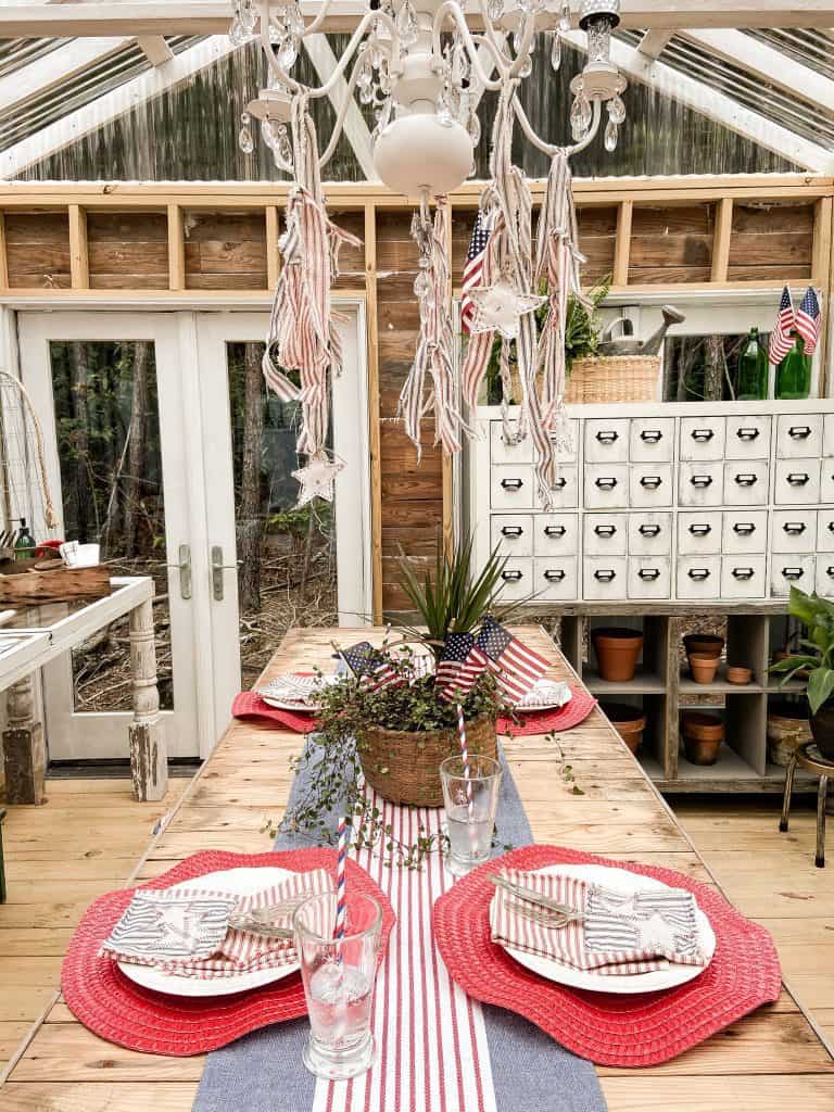 Patriotic Tablescape using ticking & drop cloth fabric scrapes, dollar store table decor and thrift store finds. Great idea for the Fourth of July  and other patriotic themed dinners.  