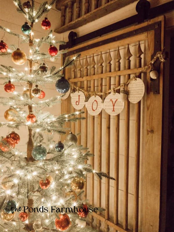 Close up of lit Christmas Tree from Christmas Past - night view with DIY Joy Garland