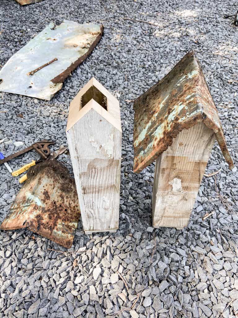 Cutting an angle on the posts allow the metal roof to fit perfectly on these DIY handmade rustic birdhouses.  