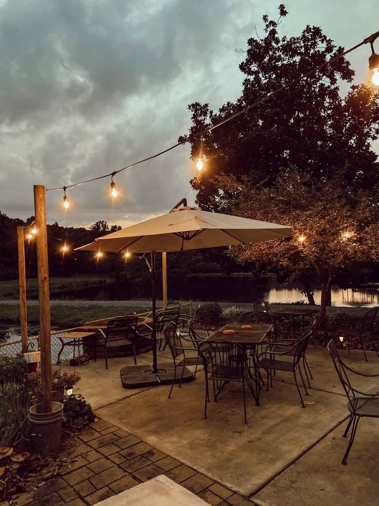 DIY Portable String Light Posts made from trashed buckets and wooden posts look great over the patio area.  Farmhouse Style, Country life