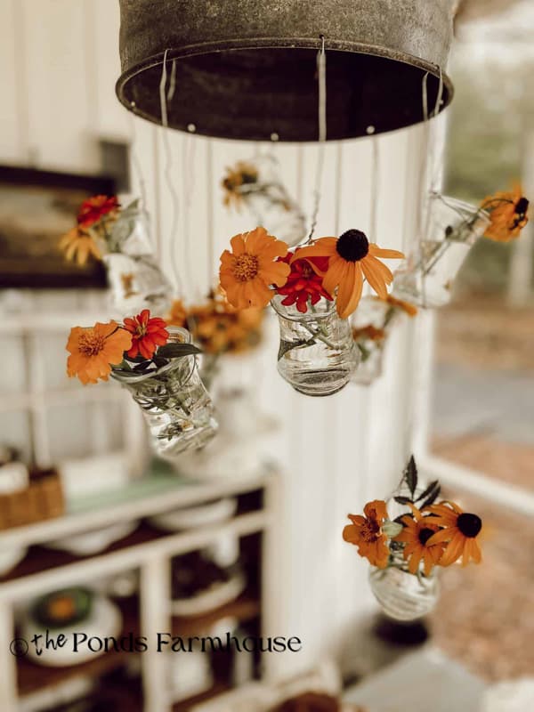black eyed susans in light fixture vases