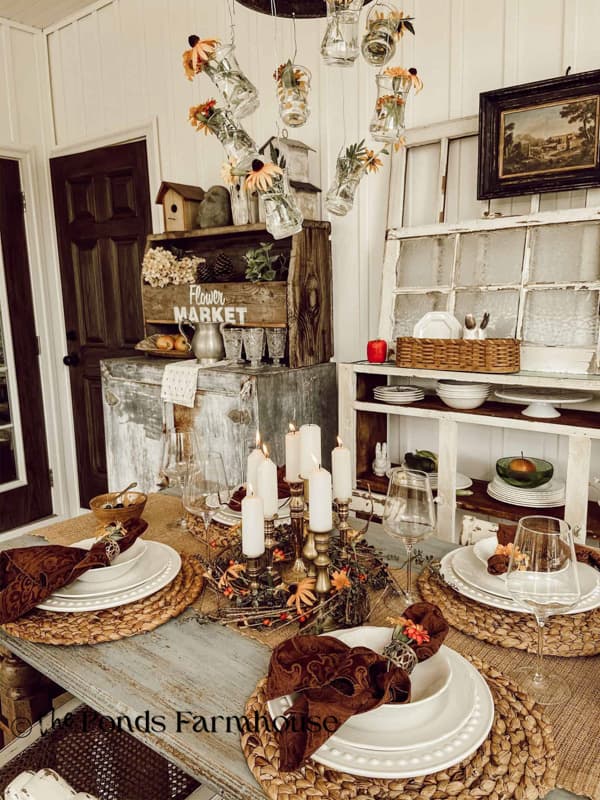 late summer to fall tablescape with black eyed susan and candle centerpiec