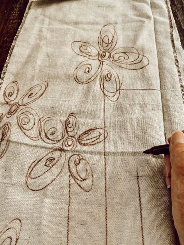 Draw Flowers with sharpie pen for DIY Tablecloth Runner upcycled drop cloth for painting. 