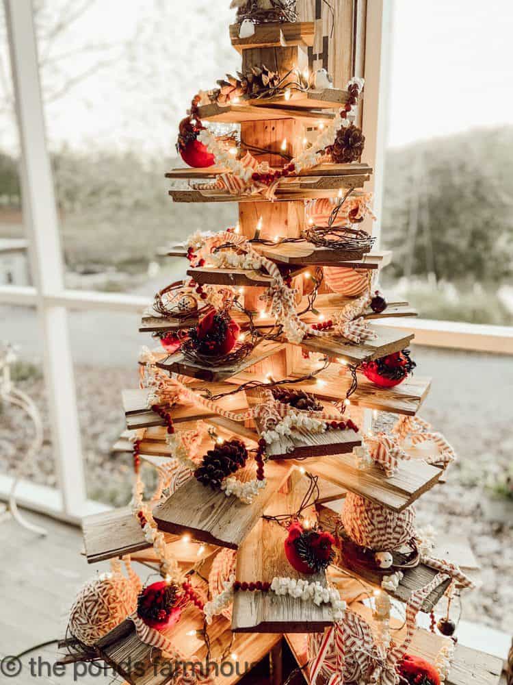 Shiplap tree decorated with red birds and ticking fabric on Christmas Decorated Porches.  