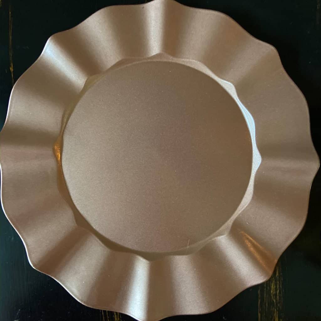 Upcycled thrift store charger plates with copper spray paint.