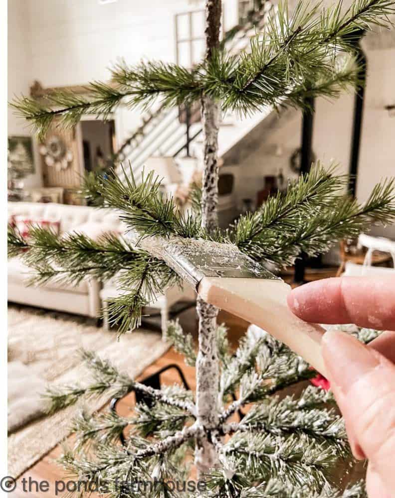 Be sure to add fake snow to the tree trunk.