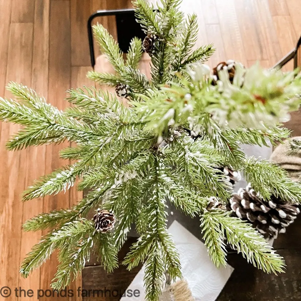 Add flocking to tips of tree branches to make faux Christmas Trees look great for Holiday Decorating