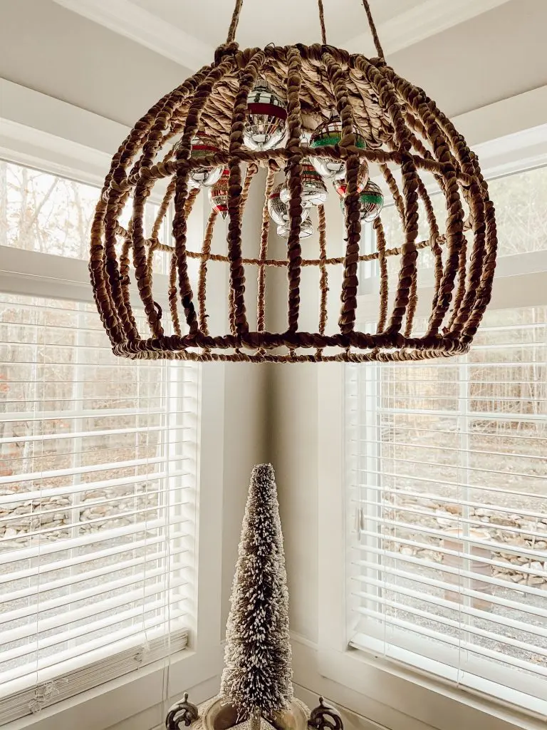Hang vintage ornaments from light fixture for a unique Christmas Decorating Idea