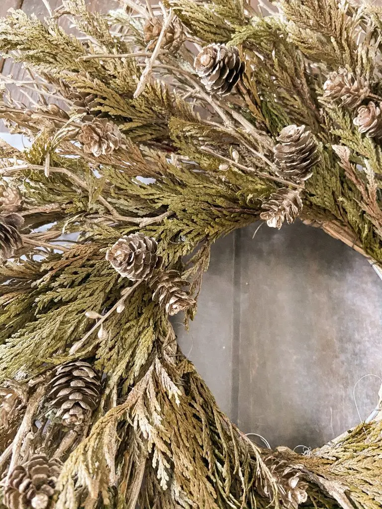 Add Flocking to an old wreath to update it for repurposed Christmas Decorating ideas.