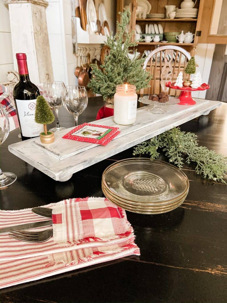 For this Easy to Make DIY Farmhouse Table Riser, you can use new wood but add a rustic appearance by distressing the wood and using a dry brush chalk paint technique. Create you own table riser with these easy to follow steps.